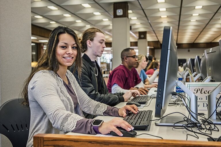Diverse students all working in a shared computer lab