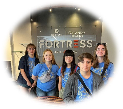 Students with image behind them with FORTRESS