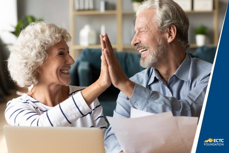 two older people high-fiving