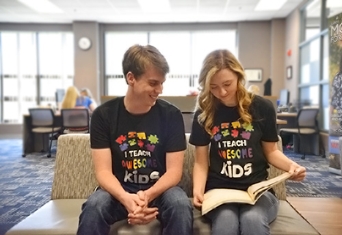 students sitting together wearing "I teach awesome kids" shirts