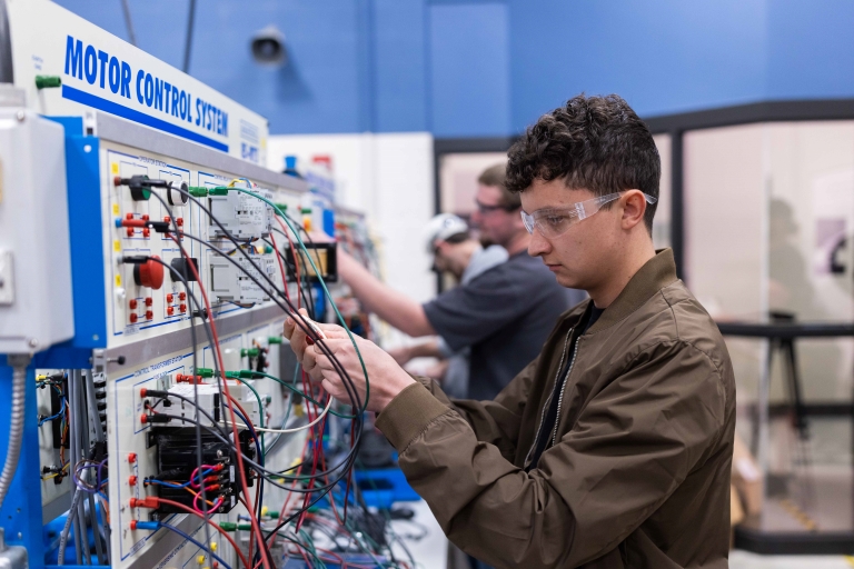 male working on wiring in a lab
