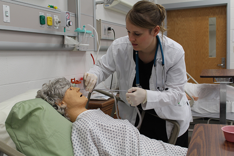 Nurse helping old woman