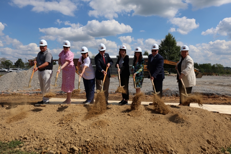 8 people shoveling dirt at the groundbreaking